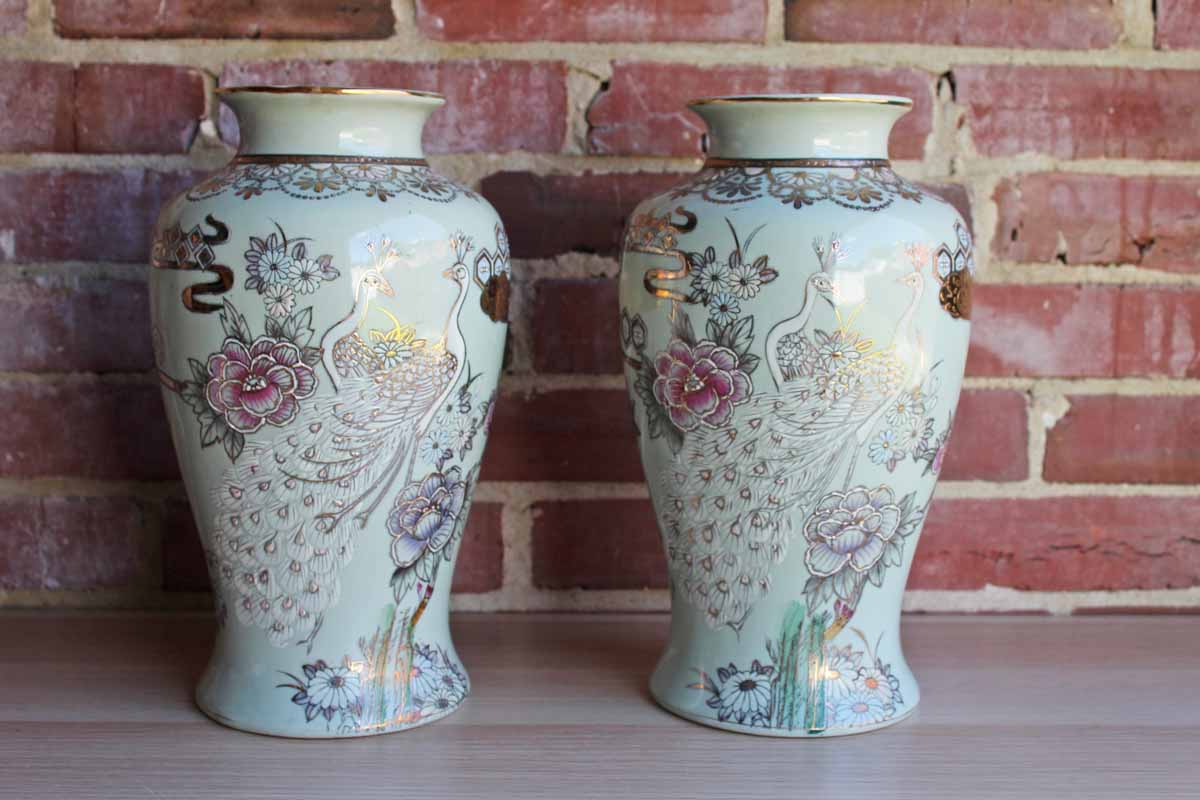 Baluster Shaped Moriaged Vases Depicting Lilac, Gold and White Peacocks and Flowers Over an Off White Background