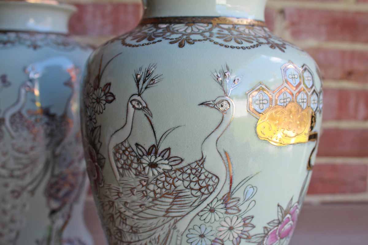 Baluster Shaped Moriaged Vases Depicting Lilac, Gold and White Peacocks and Flowers Over an Off White Background