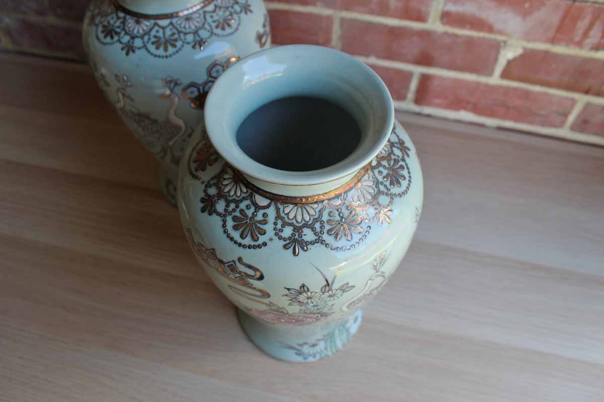 Baluster Shaped Moriaged Vases Depicting Lilac, Gold and White Peacocks and Flowers Over an Off White Background