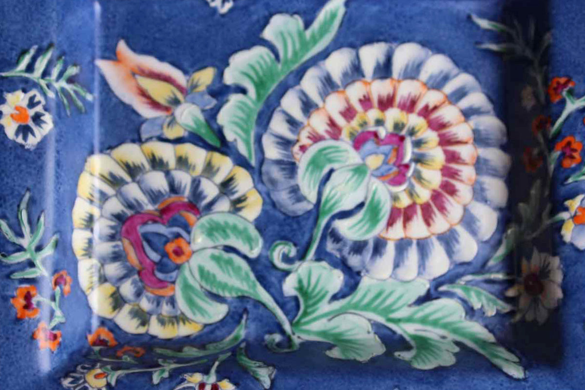Heavy Rimmed Stoneware Dish with Colorful Flowers on Blue Background