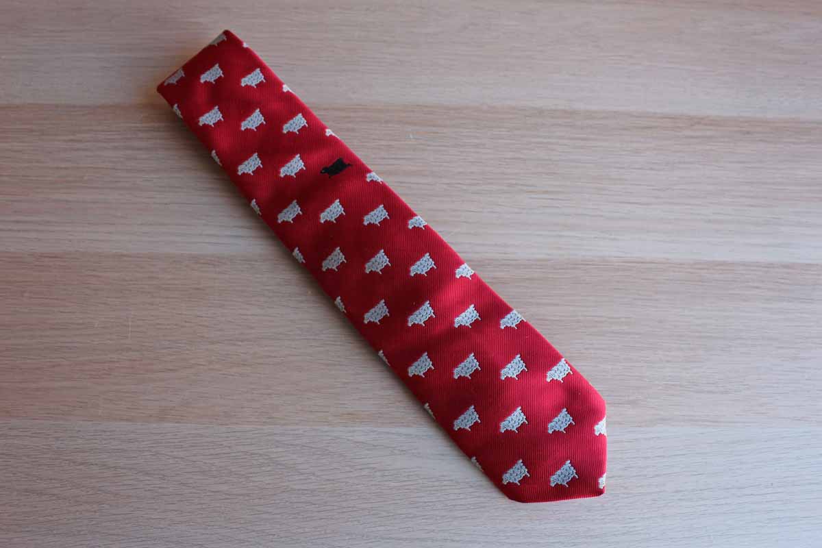 Chippmunk Creations Red Silk Polyester Blend Necktie Featuring Repeating White Sheep Pattern and One Black Sheep