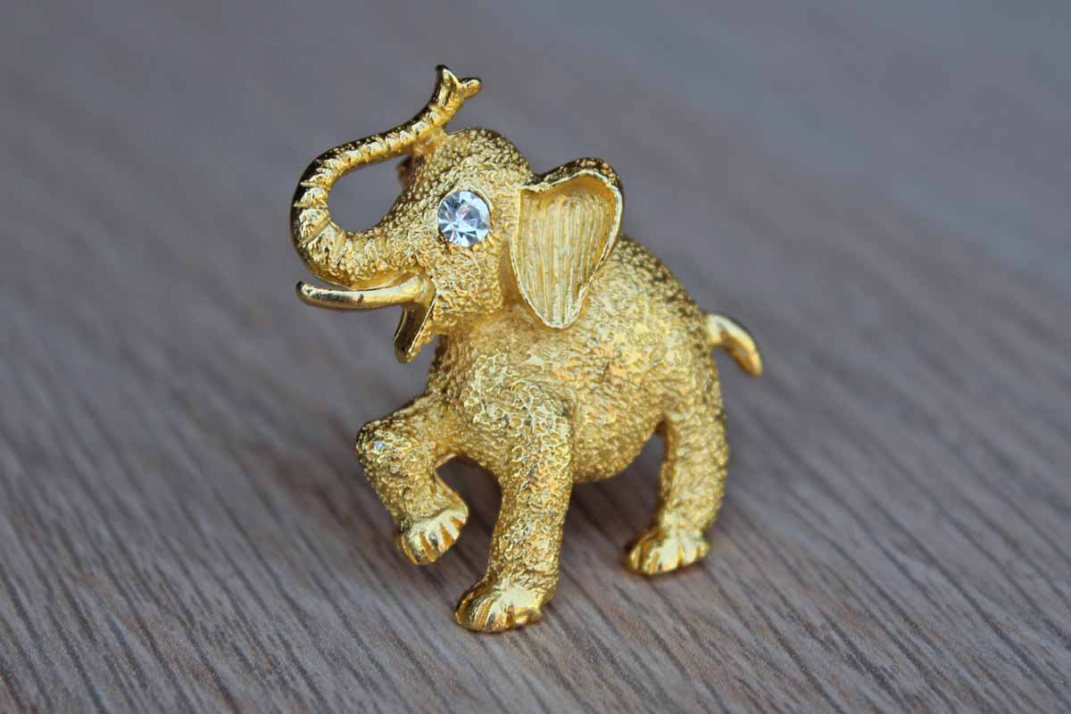 Gold Tone Metal Elephant Brooch with Silver Rhinestone Eye