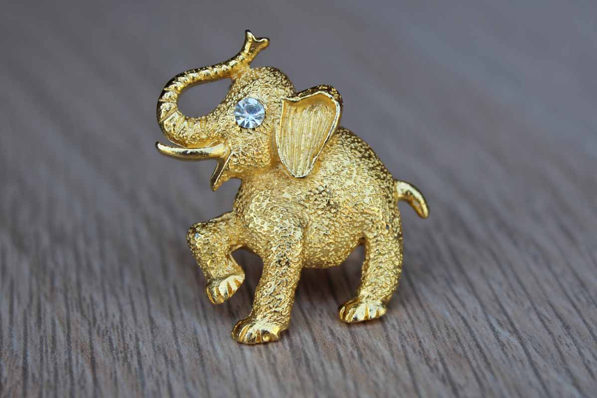 Gold Tone Metal Elephant Brooch with Silver Rhinestone Eye