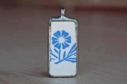 Custom-Made Charm of a Blue Cornflower Pottery Shard Encased in Silver