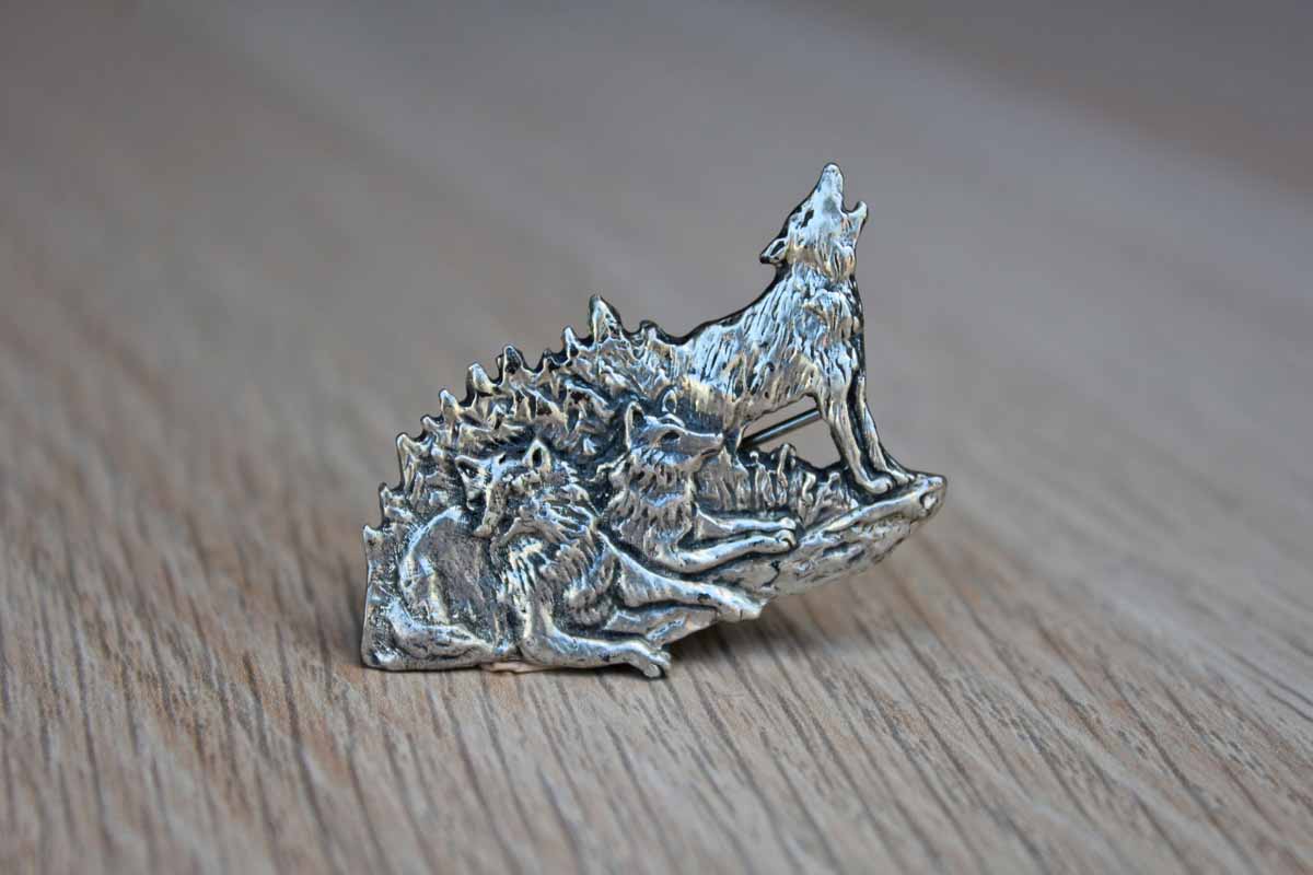 Silver Metal Brooch with Etched Rendering of a Howling Wolf with His Pack