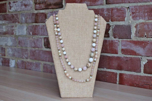 A Pair of Polished Pinkish-Purple and Cream Stone Bead Necklaces