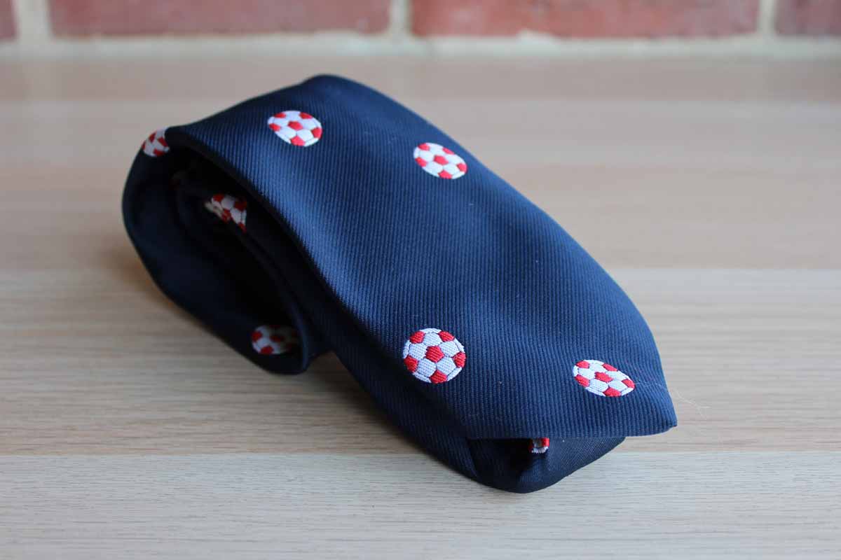 Pintail Polyester Necktie Decorated with Red and White Soccer Balls on Navy Blue Background