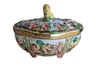 Italian Capodimonte Covered Dish with Raised Cherubs. Dogs, and Lion Finial