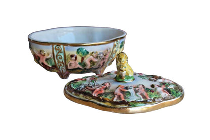 Italian Capodimonte Covered Dish with Raised Cherubs. Dogs, and Lion Finial
