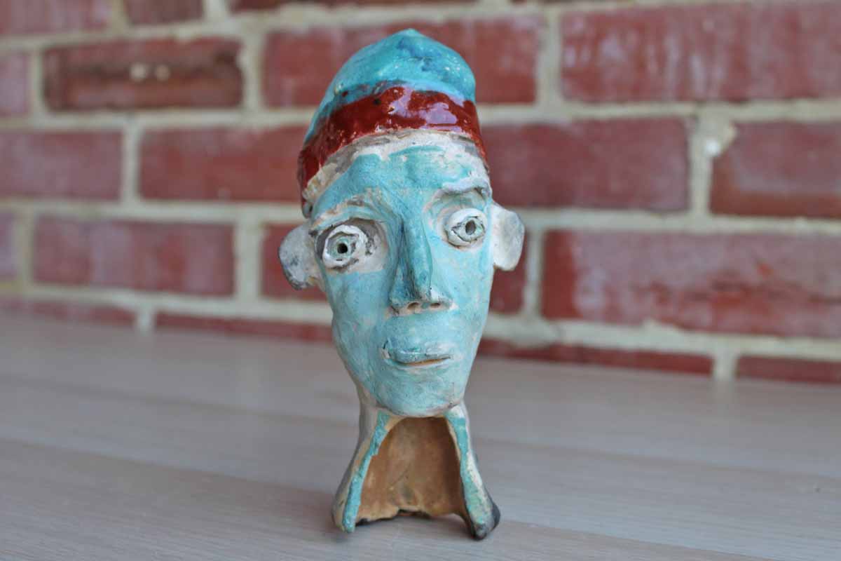 Handmade Ceramic Wall Art of Dreamlike Faces and Potted Rabbit