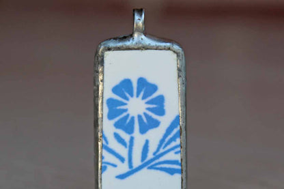 Custom-Made Charm of a Blue Cornflower Pottery Shard Encased in Silver