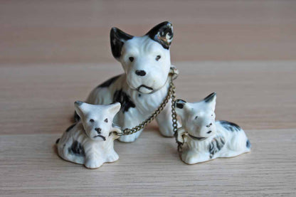 Set of Three Black and White Porcelain Terriers on Chain Leashes