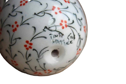 Hand-Painted Ceramic Egg with Repeating Red and Green Flower Pattern