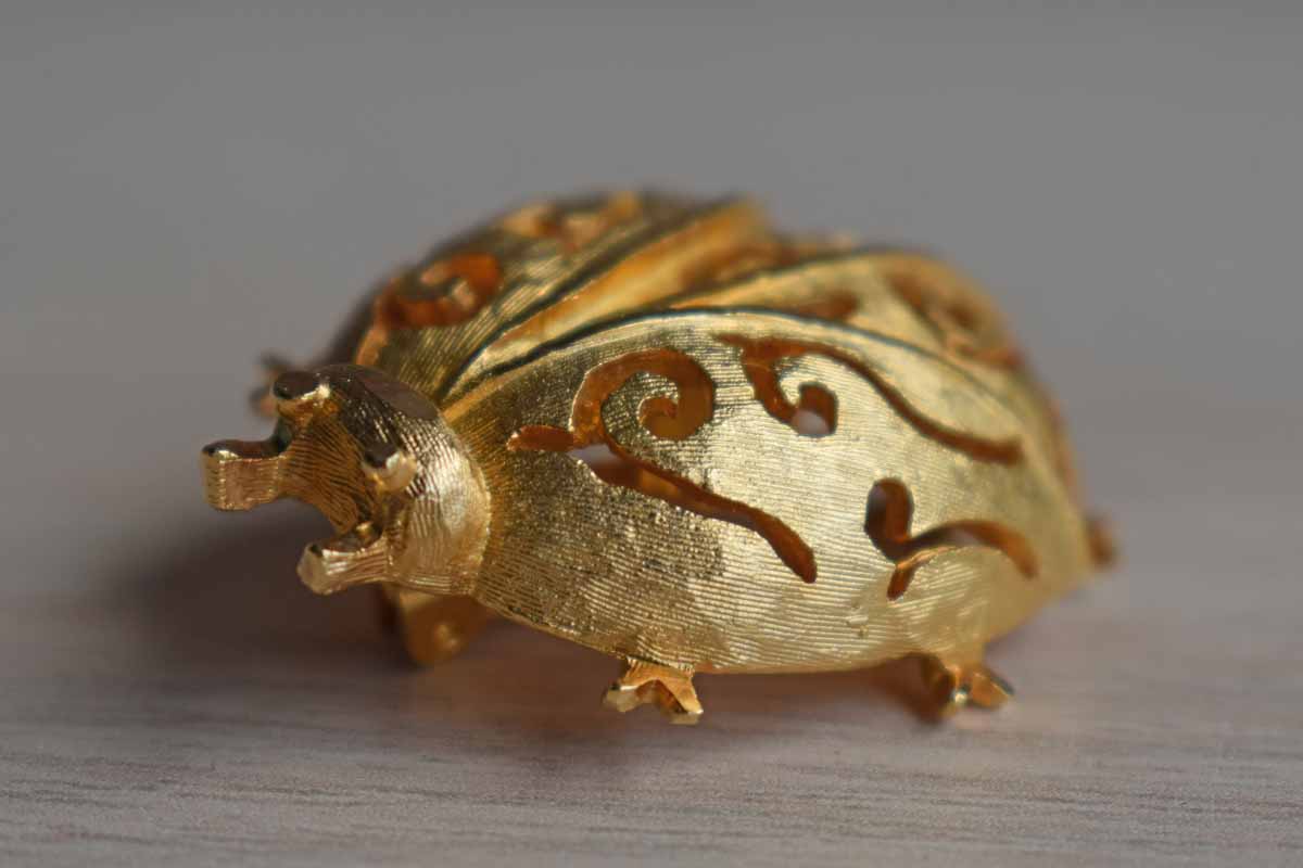 Gold Tone Metal Ladybug Brooch with Filigree Designs